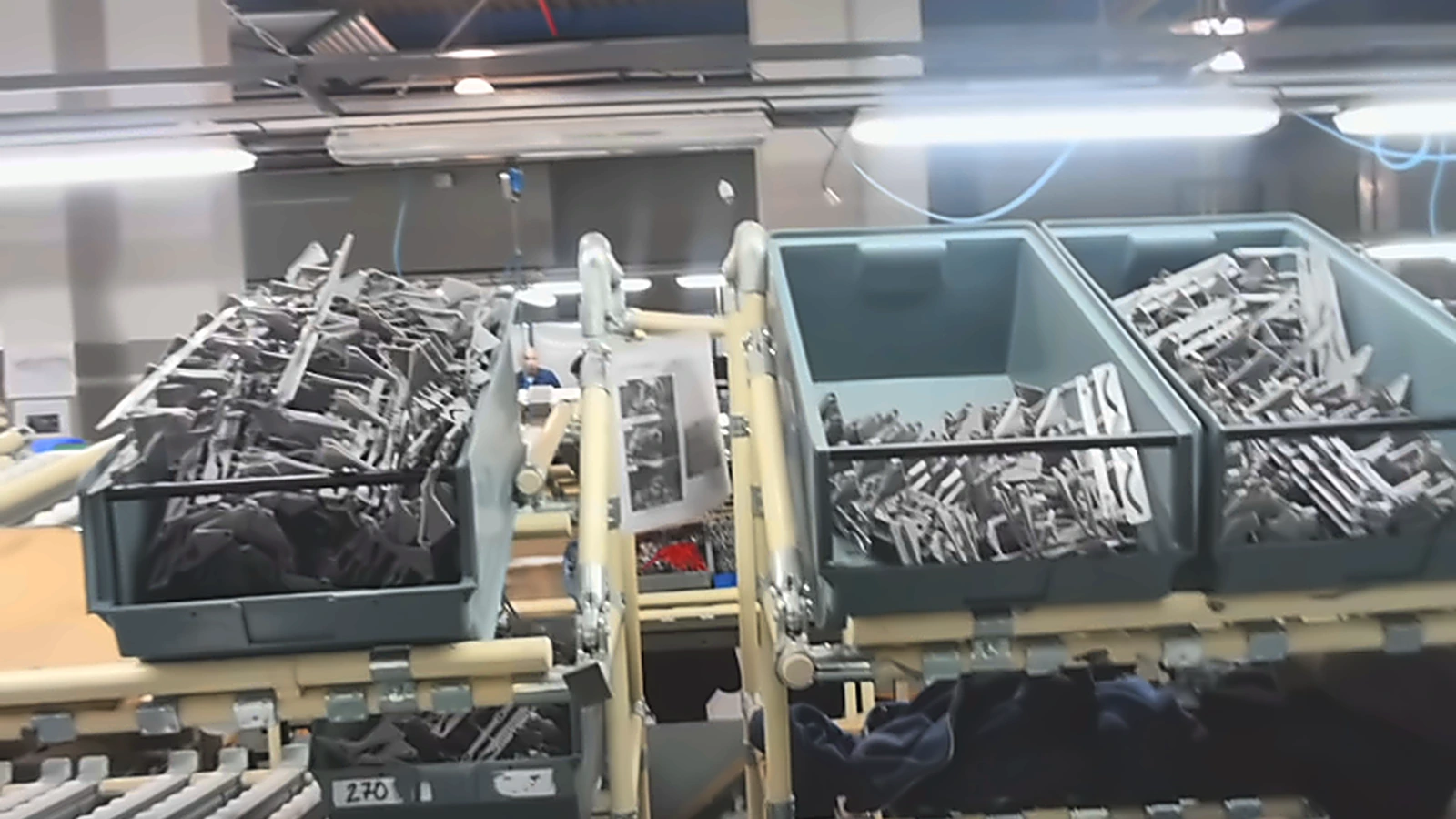 Parts bins with instruction reference visible at the assembly station
