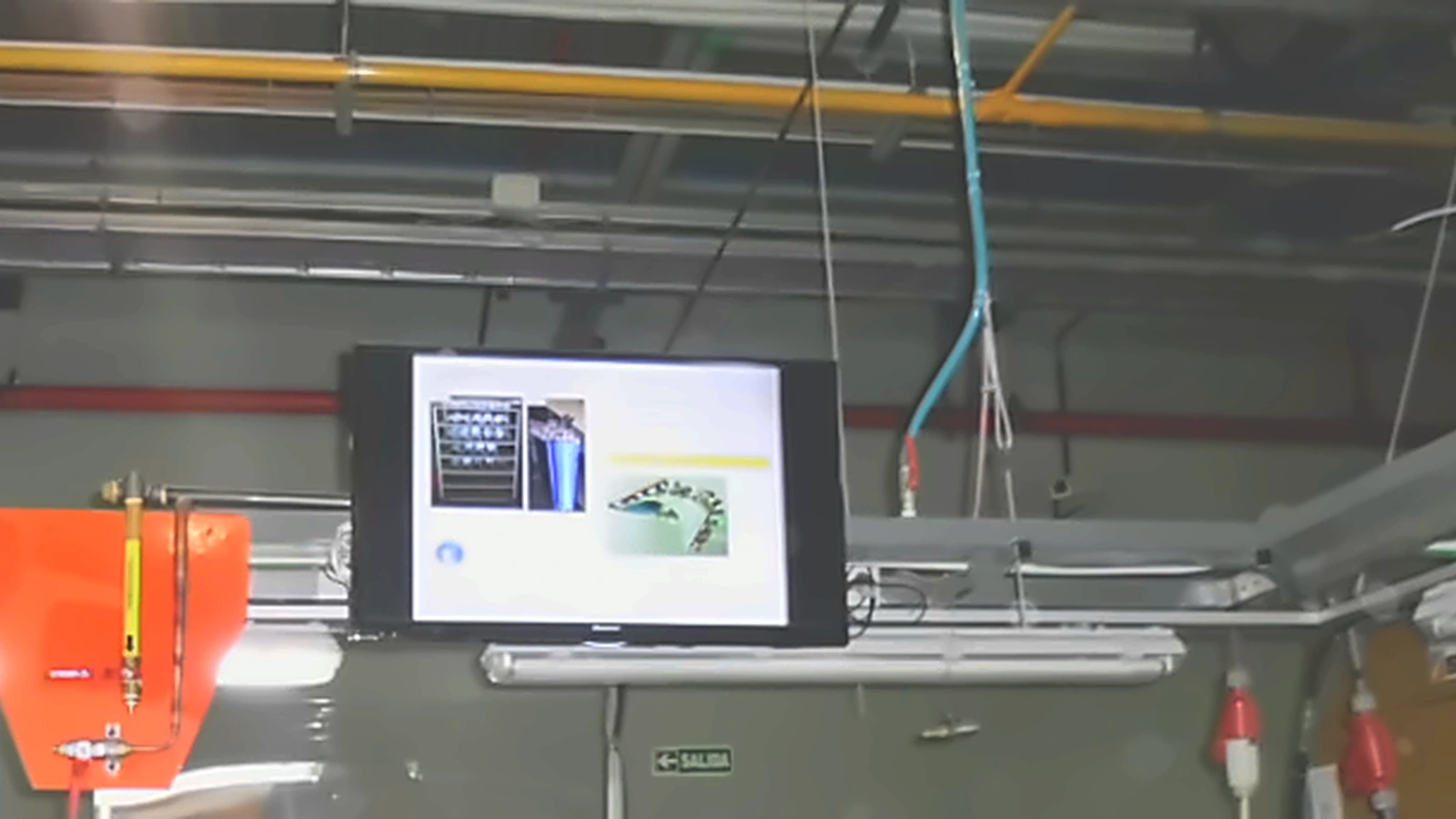 Close-up of the monitor screen displaying a digital work instruction at the workstation